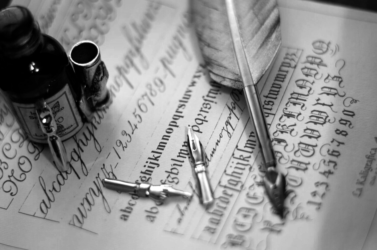 macro-shot-quill-set-ink-bottle-piece-paper-with-calligraphy-it_181624-58079