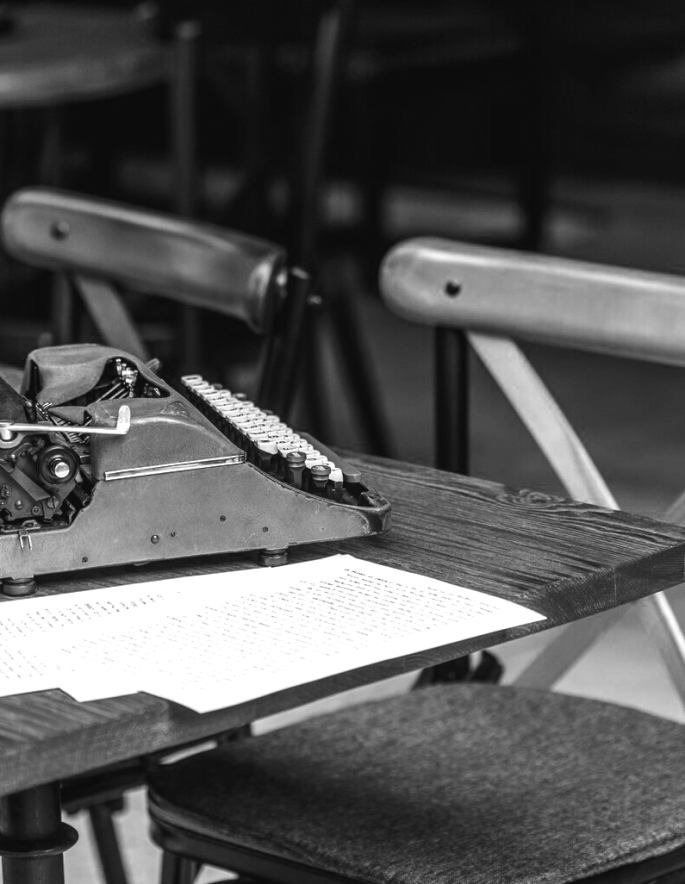 set-papers-typewriter-table-cafe-terrace-side-view_176474-4977